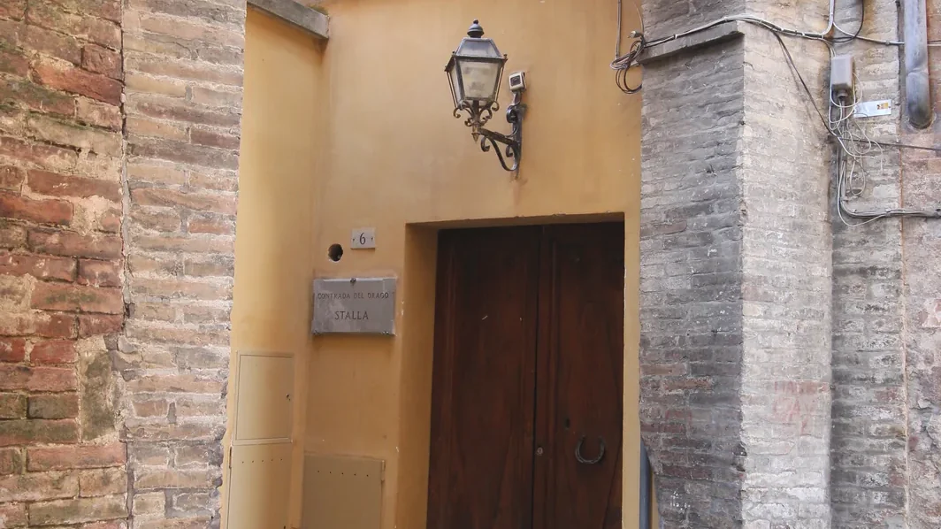 Narrow medieval lane in the Contrada del Drago area of Siena