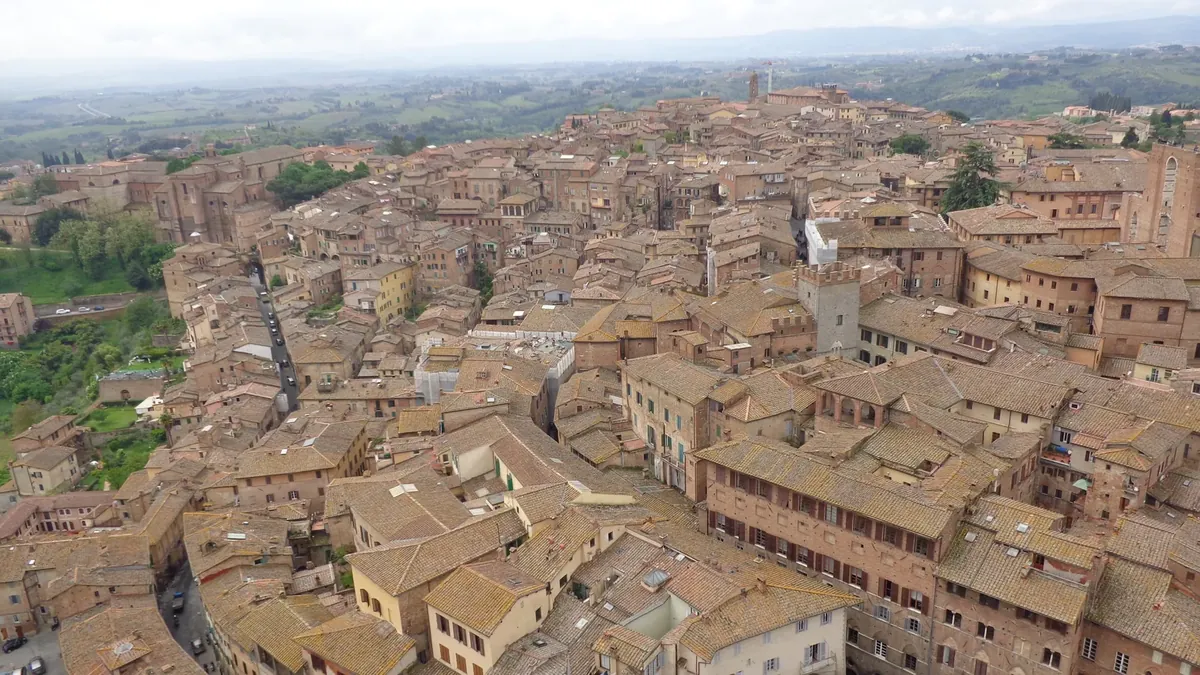 Terracotta rooftops across Siena's historic centre and surrounding Tuscan hills